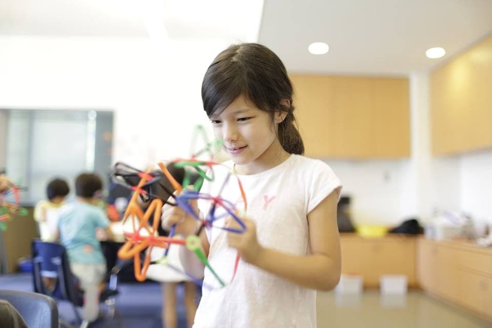 A child exploring a colorful hands-on learning activity