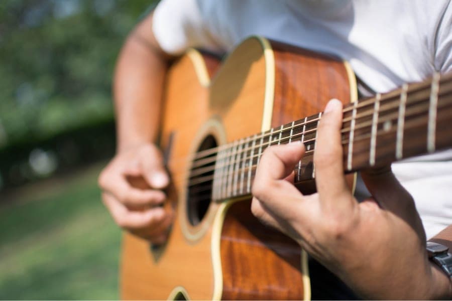 A musician playing an acoustic guitar